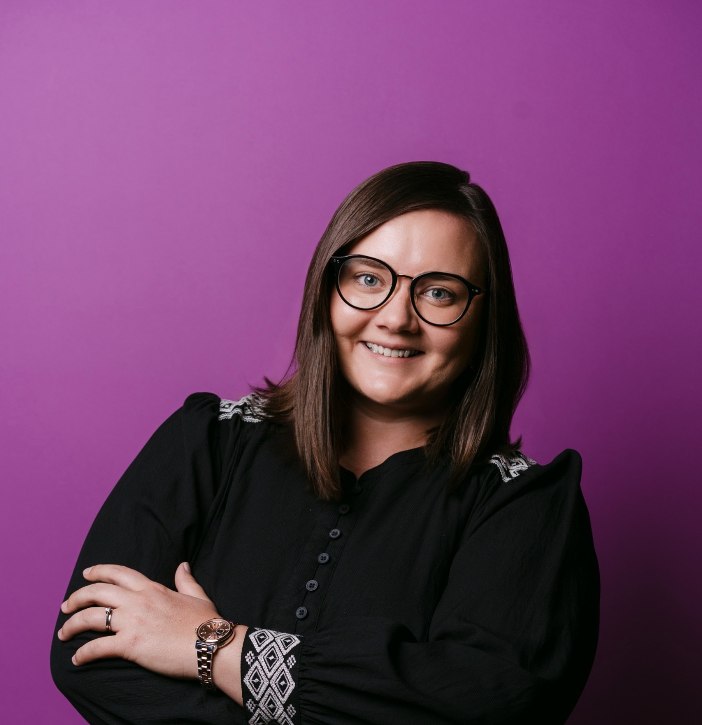 Ksenia Quinata in a portrait against a purple backdrop
